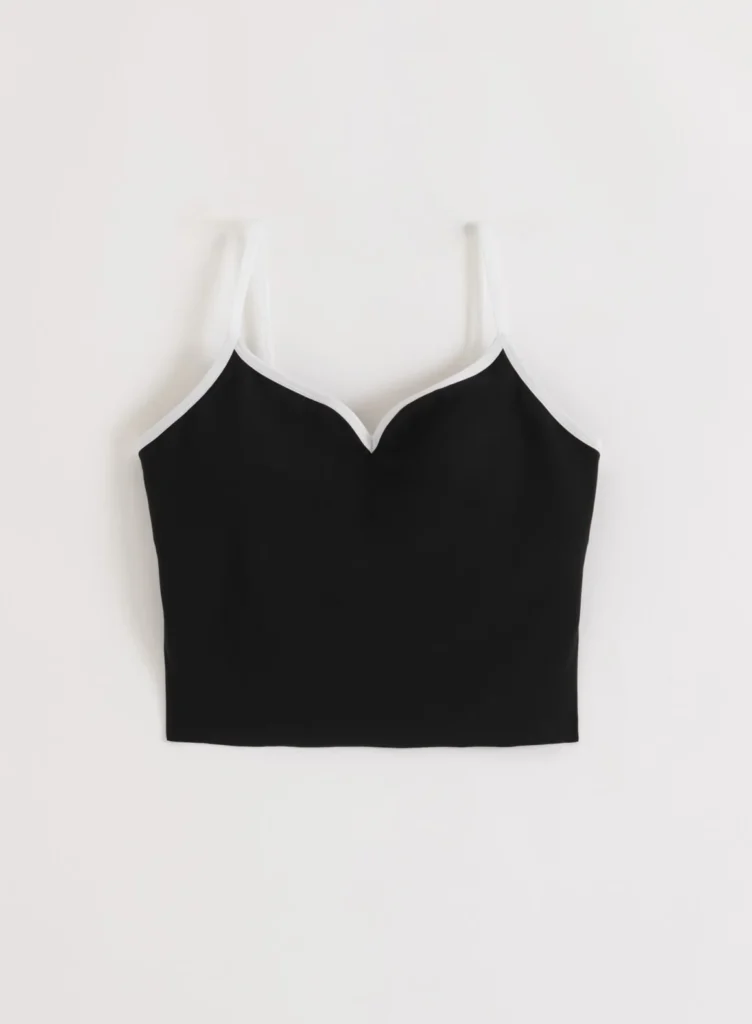 Aim'n Sense Contour Singlet 26041554-010 dames sporttop in het zwart met accentuerende contourlijnen